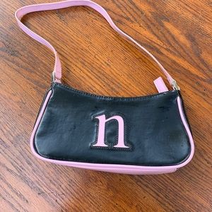 Black and pink letter “N” pocketbook